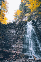 Fototapeta na wymiar autumn forest waterfall landscape view