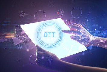Hand holdig futuristic tablet with OTT inscription, modern technology concept