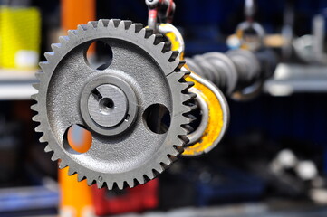  Metal gear wheel. Camshaft gear of the engine blurred background. Part of the car's engine.