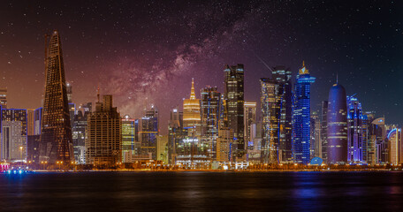 Fototapeta na wymiar Doha Qatar skyline at night showing skyscrapers lights reflected in the Arabic gulf