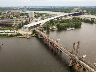 Fototapeta premium Aerial drone view. Reconstruction of a bridge over the Dnieper river in Kiev.