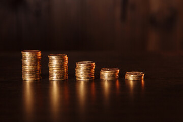 Golden coins arranged as a graph in a wooden room.