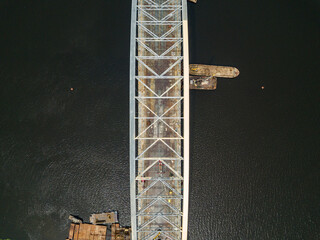 Aerial drone top view. Unfinished construction of a bridge over the Dnieper river in Kiev.