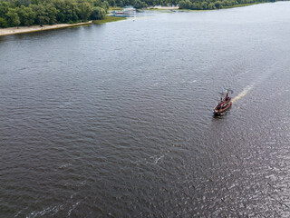 Aerial drone view. A pirate motor boat sails along the Dnieper River in Kiev.