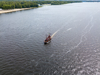 Aerial drone view. A pirate motor boat sails along the Dnieper River in Kiev.