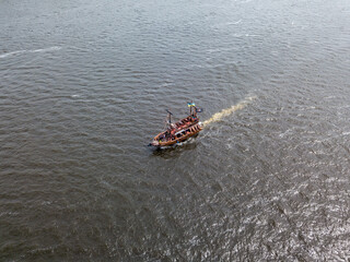 Obraz premium Aerial drone view. A pirate motor boat sails along the Dnieper River in Kiev.