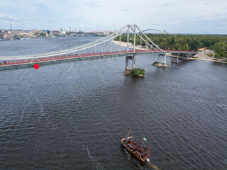 Aerial drone view. A pirate motor boat sails along the Dnieper River in Kiev.