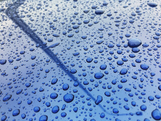 Water drops at blue car paint. Polishing and detailing cars