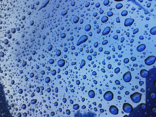 Water drops at blue car paint. Polishing and detailing cars