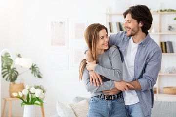 Loving couple embracing at home, spending time together