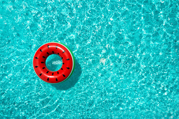 Inflatable ring floating in swimming pool, top view with space for text. Summer vacation - obrazy, fototapety, plakaty