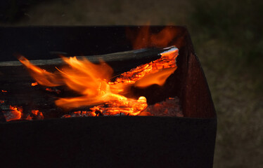 Obraz premium A picnic in the open air in a country house. Fire in the grill at night.
