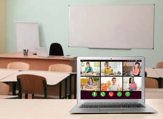 Distance education during quarantine and lockdown due to Covid-19 pandemic. Modern laptop displaying online school lesson in classroom
