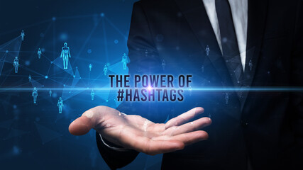 Elegant hand holding THE POWER OF #HASHTAGS inscription, social networking concept