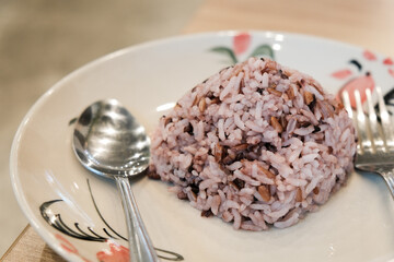 Thai steam brown rice on white plate in Thai restaurant