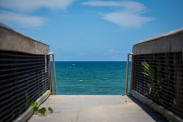 Fototapeta na wymiar Blue skies and a beautiful walkway to the beach