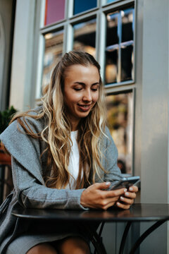 Online datting. Young beautiful woman chatting on smartphone