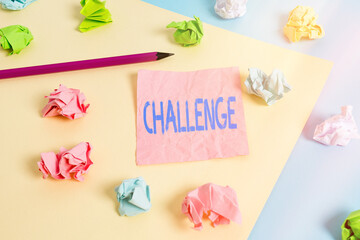 Conceptual hand writing showing Challenge. Concept meaning process of provoking or testing physiological activity by exposure Colored crumpled papers empty reminder blue yellow clothespin
