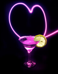 Glass of cocktail in a dark room and neon light trails