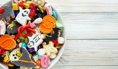 Halloween Jack o Lantern candy bowl with candy and halloween cookies Trick or Treat on white background