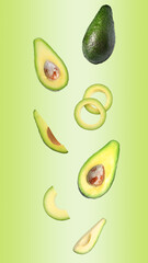 Fresh ripe avocados falling on color background