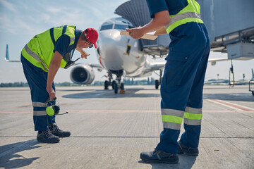 Aircraft maintenance technicians carrying out a post-flight inspection