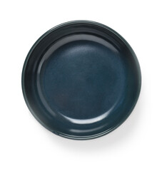 Empty dark blue ceramic bowl or ramekin isolated on a white background. Empty crockery for food design. Clay, ceramics or porcelain tableware.