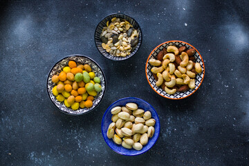 Sunflower and pumpkin seeds in bowl on the blue background. Large group of seeds. Snack and appetizer.