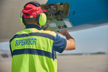 Aircraft engineer servicing the plane prior to the departure