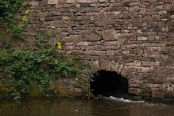 Water outlet  to bypass the lock in Peak Forest Canal, Greater Manchester. 