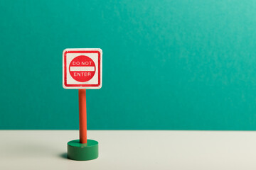 Child's wooden toy 'Do Not Enter' road sign with a teal background  