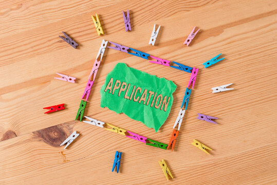 Conceptual hand writing showing Application. Concept meaning computer program that is designed for a particular purpose Colored crumpled papers wooden floor background clothespin