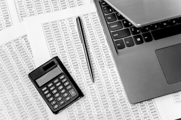 Top view of working space with financial reports, laptop, calculator and pen. Top view. Business planning concept on white.