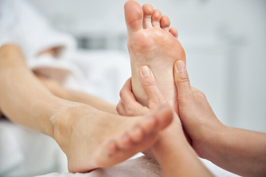 Woman having feet treated in spa salon