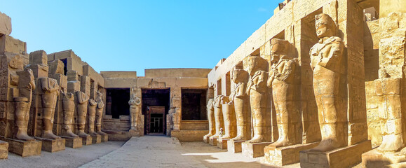 Parallel lines of statues in the temple complex at Karnak near Luxor, Egypt in summer