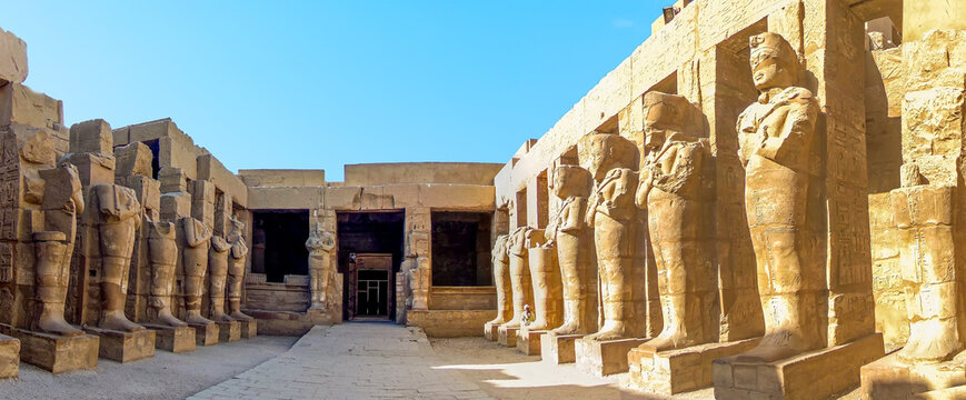 Parallel lines of statues in the temple complex at Karnak near Luxor, Egypt in summer