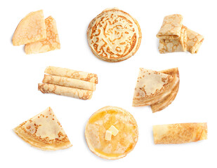 Set of tasty thin pancakes on white background, top view