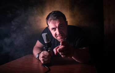 Serious reporter in television studio looking at the camera