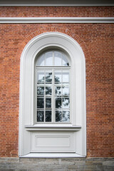 Window on the red brick wall old building