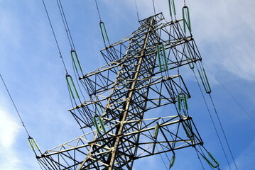 power line pole against a blue sky with clouds
