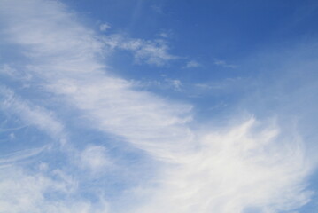 feather clouds on a blue sky background