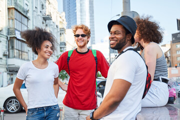 Cheerful four people strolling around in downtown