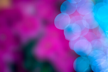 abstract background of blue bokeh and pink bokeh on a black background.