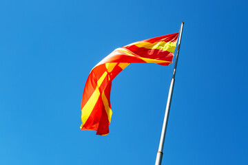 North macedonia flag waving in sunny blue sky