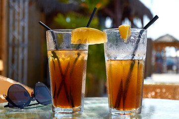 Cocktails on the beach. Bright cold drinks on the beach in summer. Summer vacation and travel concept.