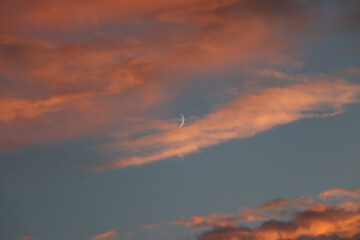 moon on a background of clouds and blue sky, sunset