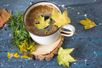 Autumn still life. Cup of tea with maple autumn leaves and inscription Hello autumn on the white background. Autumn seasonal background, autumn card with Hello Autumn concept.
