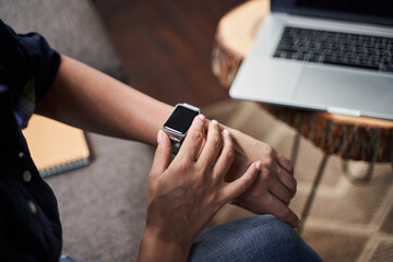 Female person checking the time with modern device