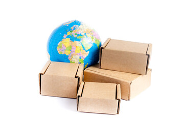 Earth globe is surrounded by boxes isolated on white background. Global business and international transportation of goods products. Shipping freight, world trade and economics. 