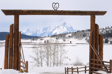 Gate Arch of Heart Six Ranch in Buffalo Valley in winter framing Grand Teton Peaks Wyoming